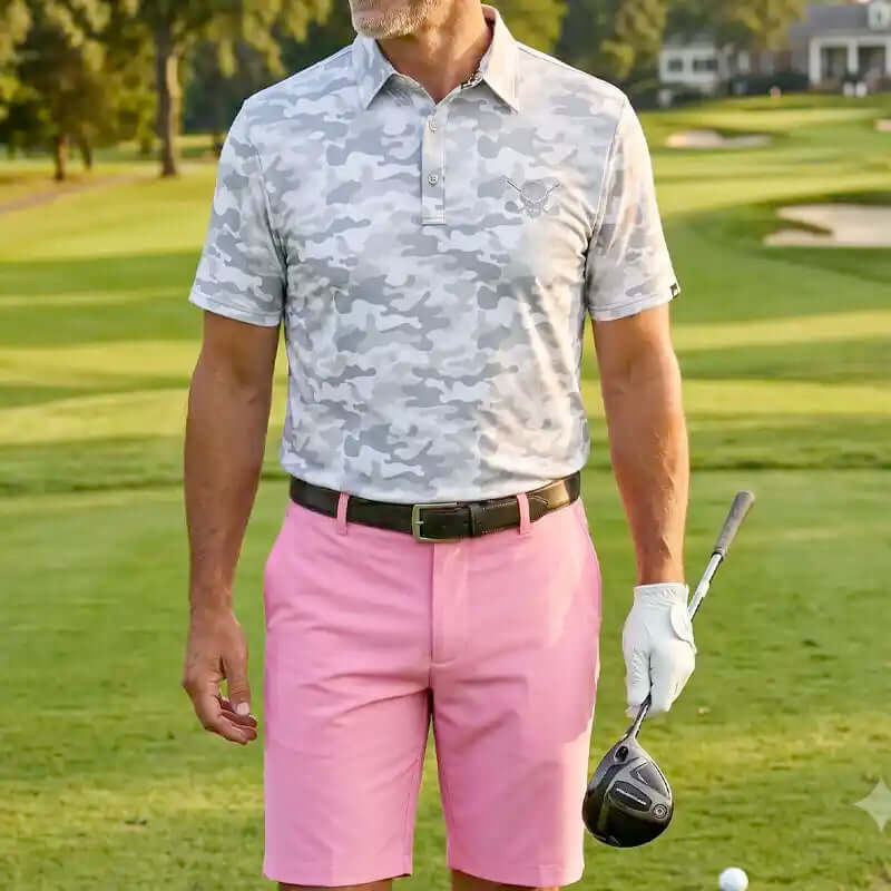 Man in camouflage shirt and pink shorts holding a golf club