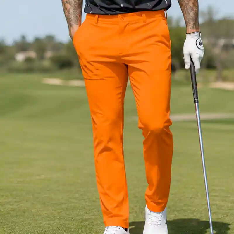 Person wearing crazy bright orange golf pants on a golf course