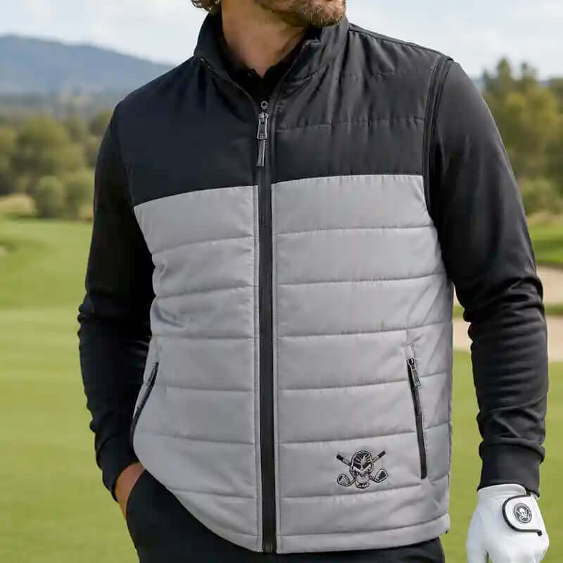 Man wearing a black and gray quilted vest on a golf course