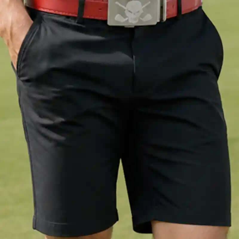 Black golf shorts with a red belt featuring a skull.