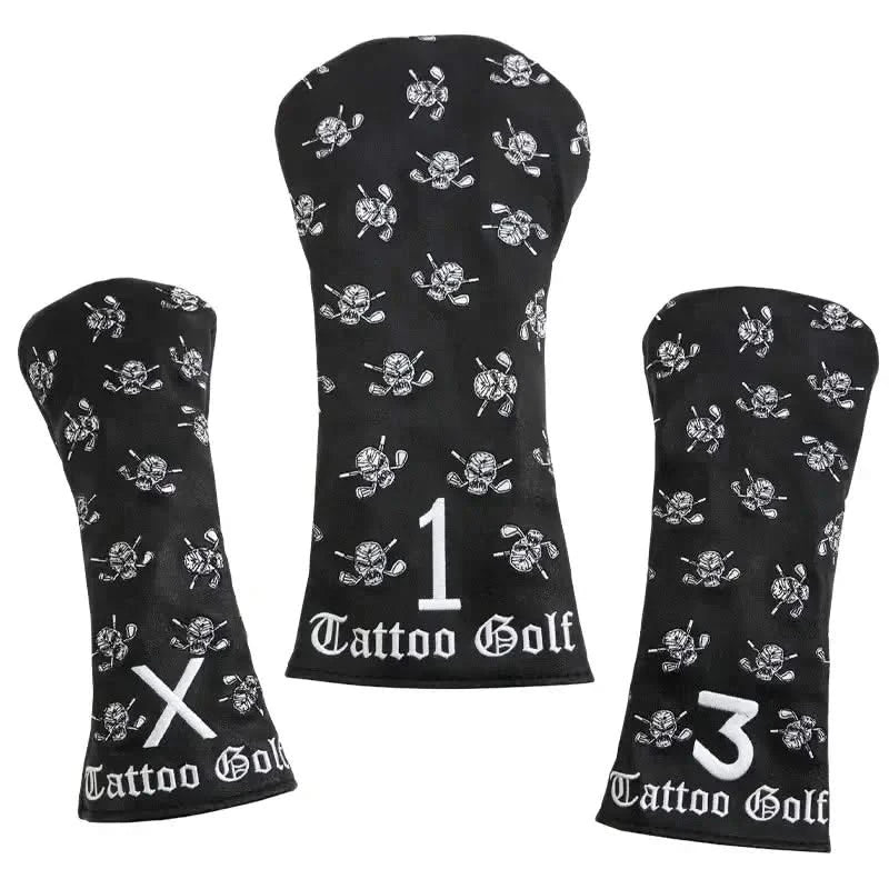Three black faux-leather golf club covers with embroidered designs including a skull and crossed clubs, and the Tattoo Golf brand logo.
