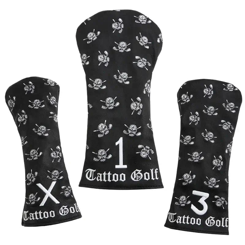 Three black faux-leather golf club covers with embroidered designs including a skull and crossed clubs, and the Tattoo Golf brand logo.