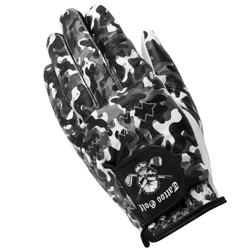 A man's hand wearing a white, black, and gray camouflage patterned golf glove with a visible logo on the back.
