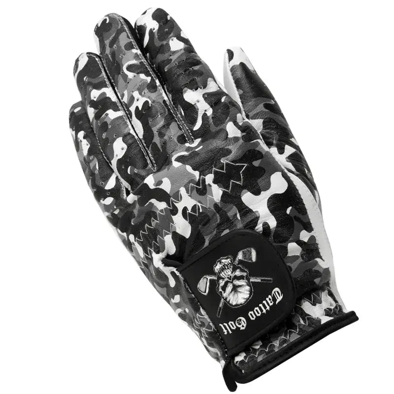 A man's hand wearing a white, black, and gray camouflage patterned golf glove with a visible logo on the back.