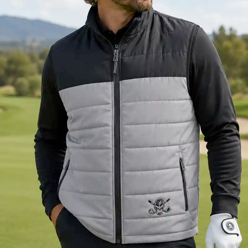 Man wearing a black and gray quilted vest on a golf course