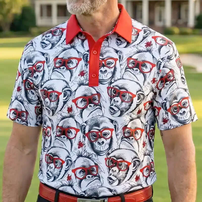 Man wearing a monkey patterned golf shirt with monkeys and red glasses on a grassy background