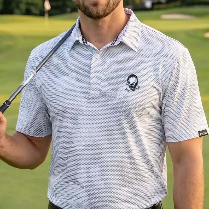 Man wearing a white rogue patterned polo shirt with a skull design on a golf course