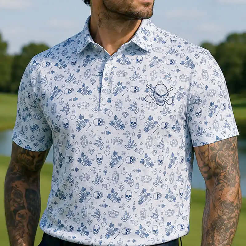 tattooed man wearing a white polo shirt with blue skull pattern outdoors