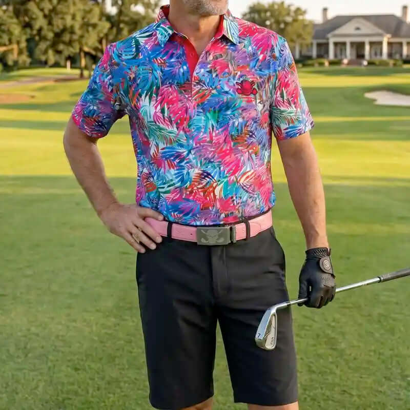 golfer in colorful golf shirt and black shorts holding a golf club on a golf course