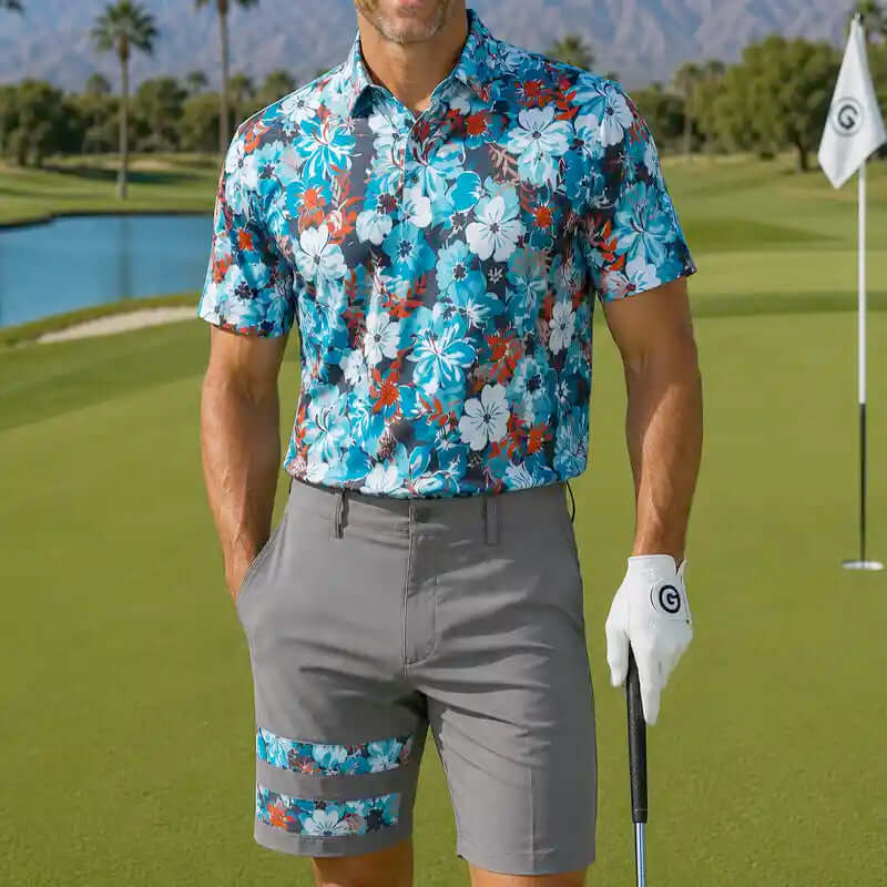 golfer in floral shirt and gray shorts holding a golf club on a golf course.