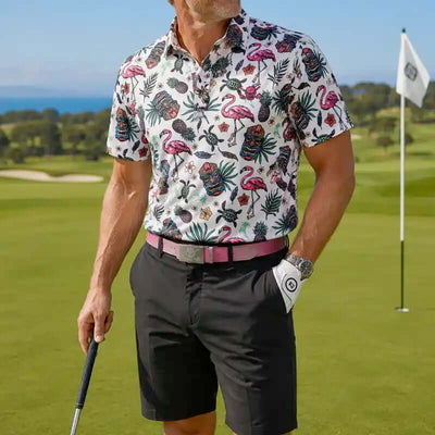 Man in a colorful floral tiki shirt and black shorts on a golf course