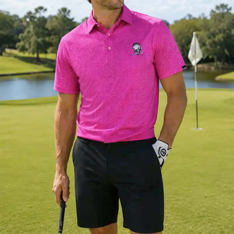 Person wearing a pink polo shirt and black shorts on a golf course