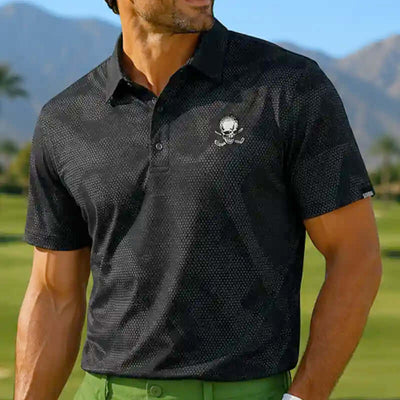 Man wearing a black rogue polo shirt with a skull design on a golf course