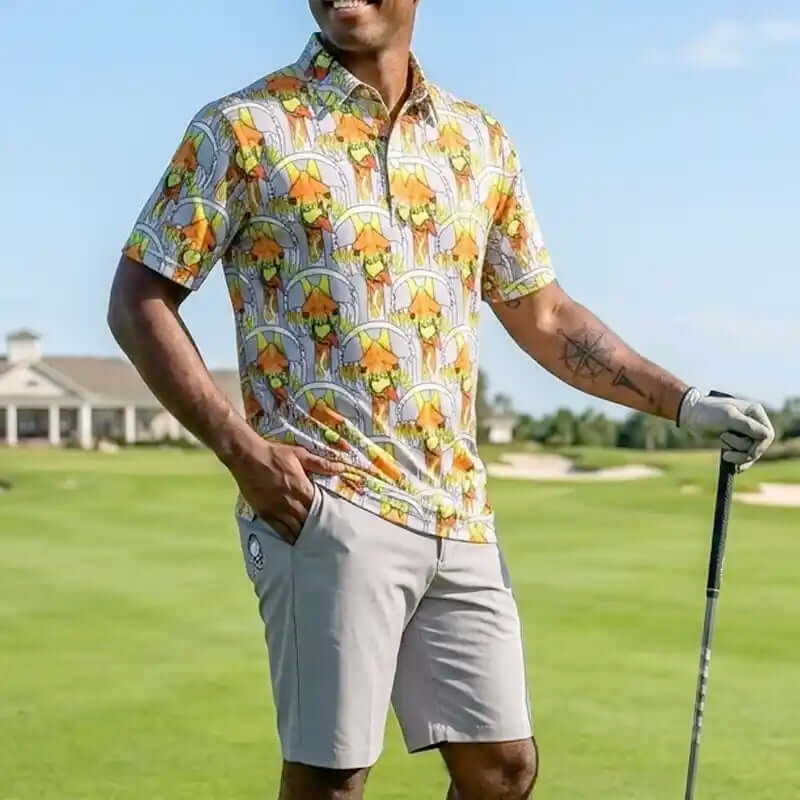 fun colorful golf shirt with giraffe print and gray shorts holding a golf club on a golf course.