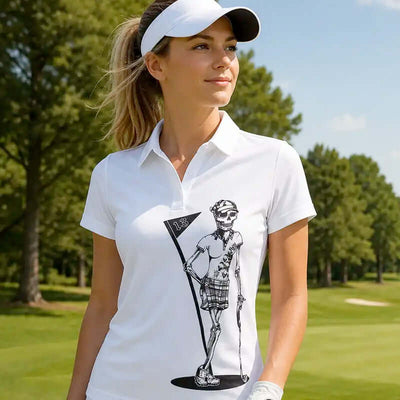Woman wearing a white polo shirt with a graphic design on a golf course