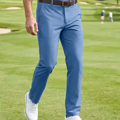 golfer wearing blue golf pants on a golf course. Best men's golf pants