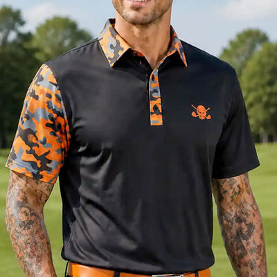tattooed man wearing a black polo shirt with orange and camouflage sleeves and collar, standing outdoors.