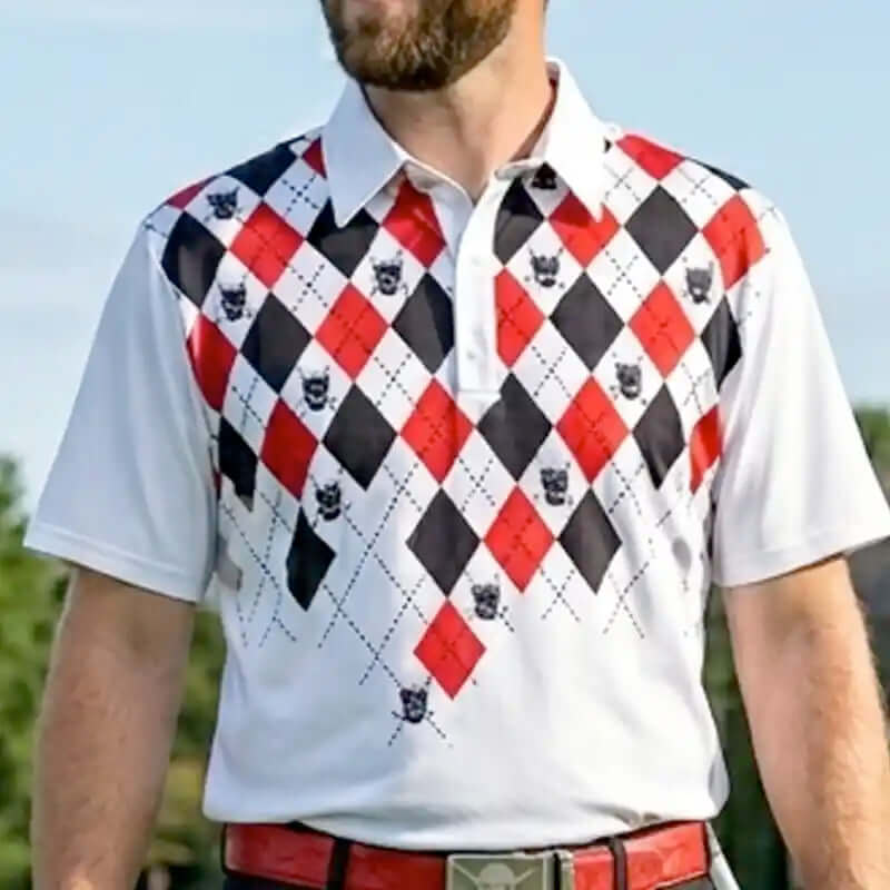 Man wearing a white monster polo shirt with red, black, and white argyle pattern outdoors.