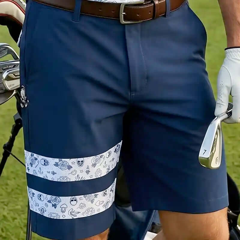 Navy blue golf shorts with a patterned band worn by a person on a golf course.