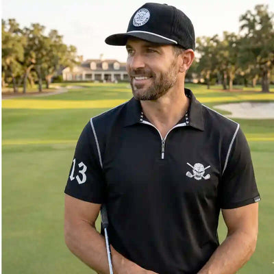Man in black golf attire with a cap on a golf course
