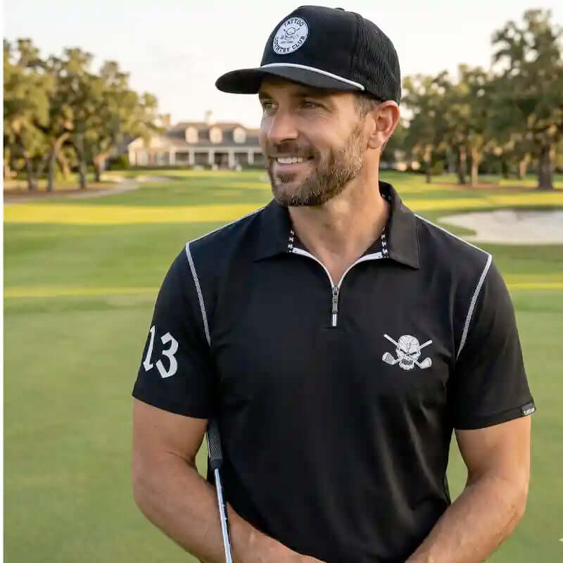 Man in black golf attire with a cap on a golf course
