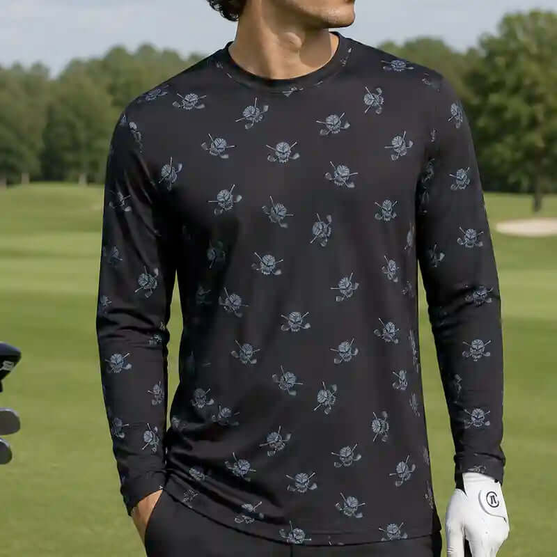 golfer wearing a black long-sleeve shirt with skull and crossbones pattern on a golf course.