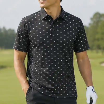 Man wearing a black skull patterned polo shirt on a golf course