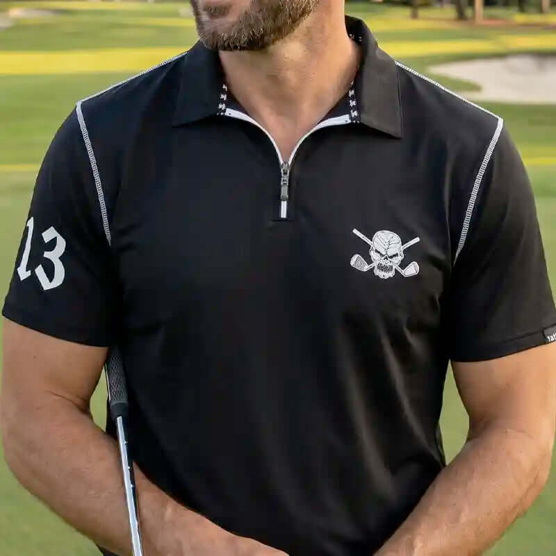 Man wearing lucky 13 golf  with a skull and crossing clubs design on a golf course