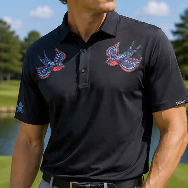 Black polo shirt with birdie designs on a blurred golf course background