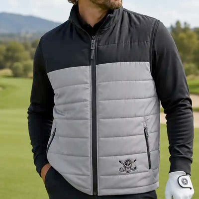 Man wearing a black and gray quilted vest on a golf course