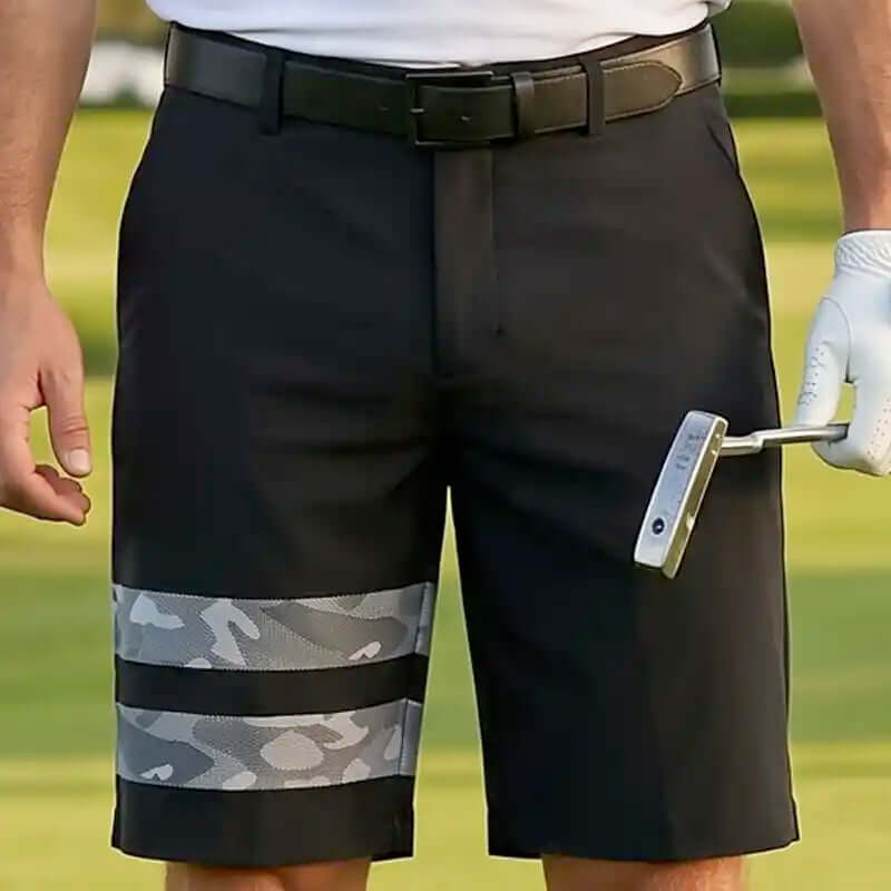 Black golf shorts with camouflage pattern on a golf course