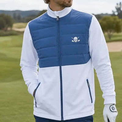 man wearing a blue and white golf jacket with a skull logo on a golf course