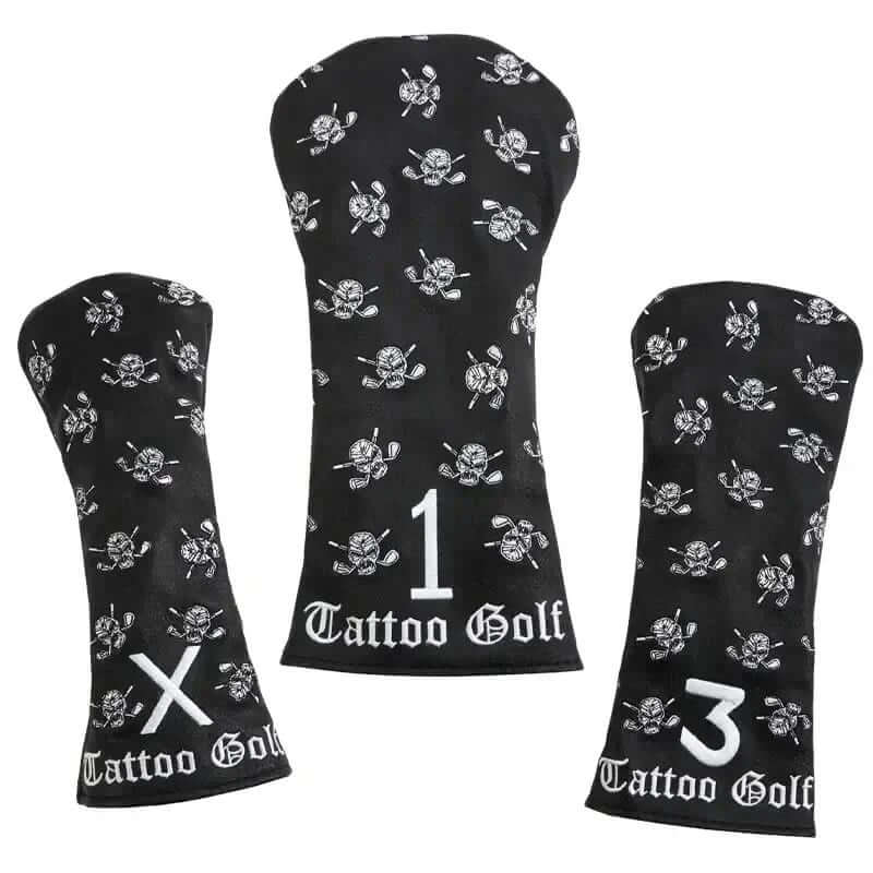 Three black faux-leather golf club covers with embroidered designs including a skull and crossed clubs, and the Tattoo Golf brand logo.