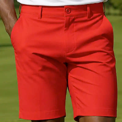Red golf shorts worn by a person on a golf course
