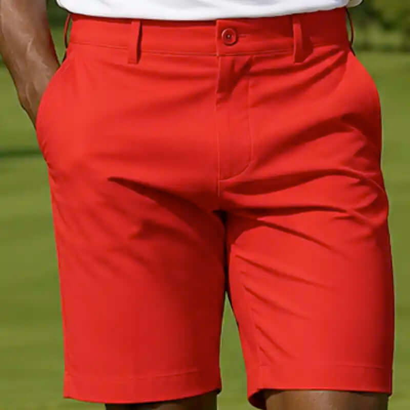 Red golf shorts worn by a person on a golf course