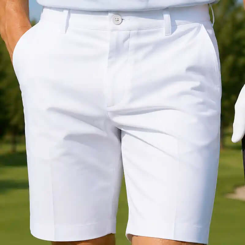 White golf shorts worn by a golfer on a grassy background