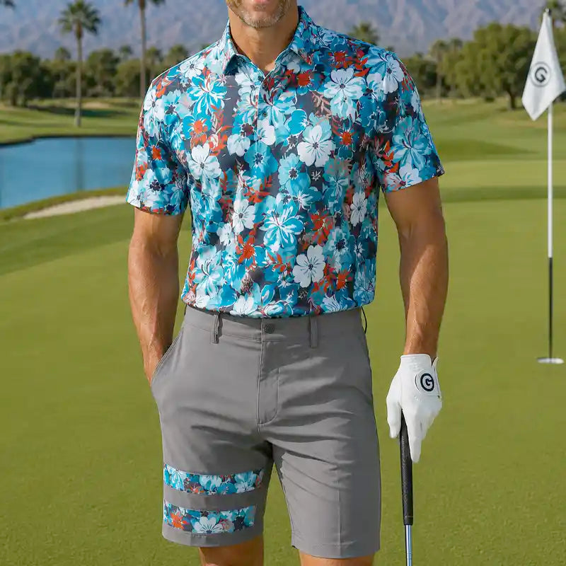 golfer in floral shirt and gray shorts holding a golf club on a golf course.