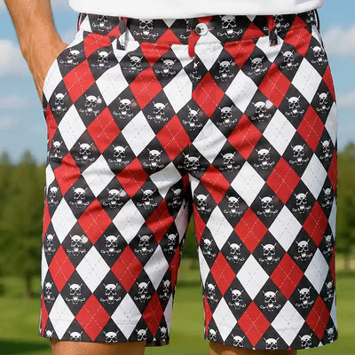 Tattoo Golf Monster ProCool golf shorts in red, black and white argyle, worn by a golfer outdoors.