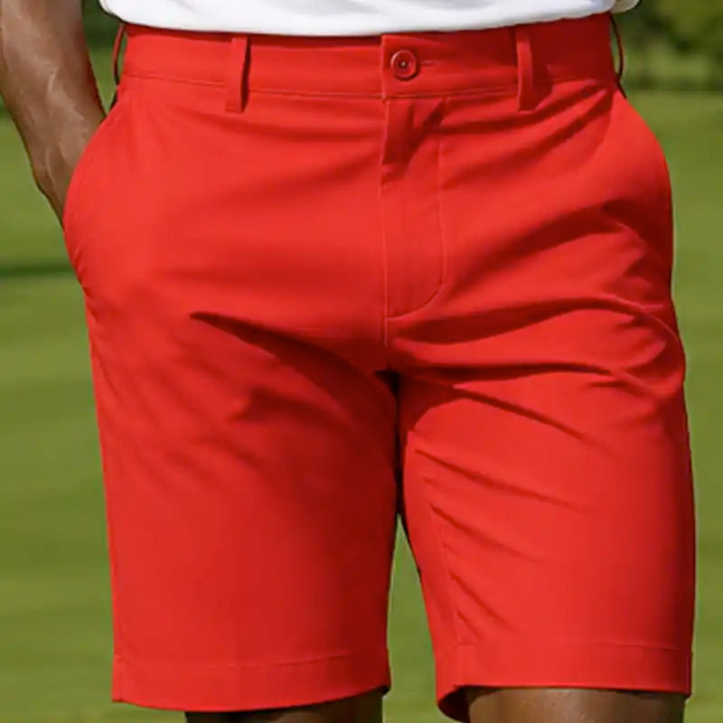 Red golf shorts worn by a person on a golf course