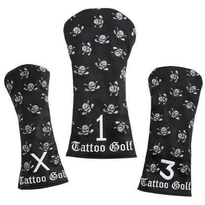 Three black faux-leather golf club covers with embroidered designs including a skull and crossed clubs, and the Tattoo Golf brand logo.