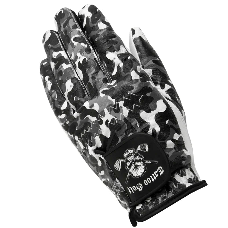 A man's hand wearing a white, black, and gray camouflage patterned golf glove with a visible logo on the back.