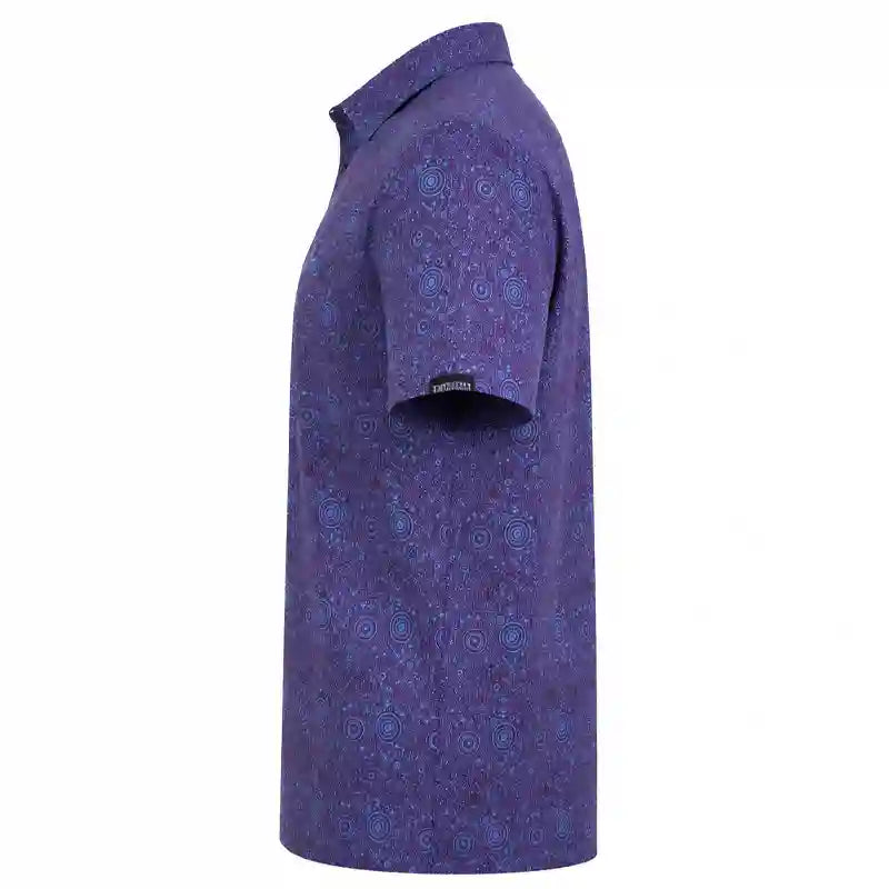A short-sleeve button-up polo shirt shown from the side, featuring an all-over abstract blue and purple pattern on a purple base, with a small black brand tag on the sleeve.