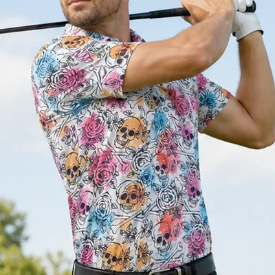 Person wearing a colorful shirt with skull and flower pattern holding a golf club.