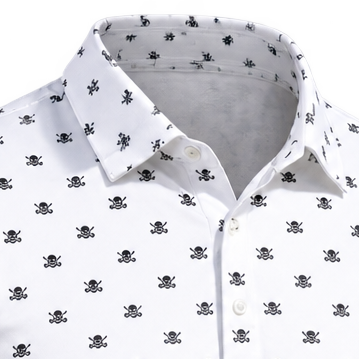 Close-up of a white polo's collar and repeating black skull-and-crossed-clubs pattern.
