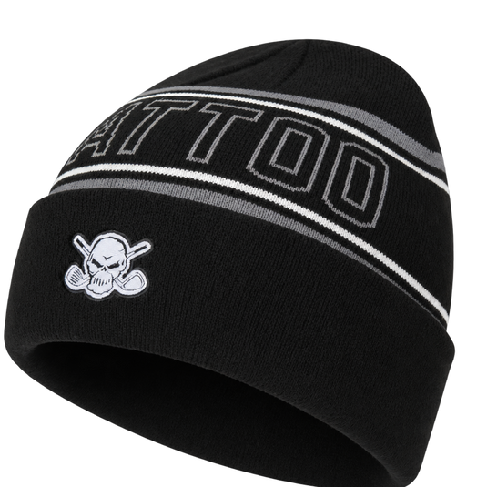 Closer angled view of a black TATTOO-lettered beanie and skull patch.