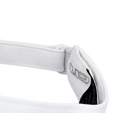 Close-up of a white visor's adjustable strap and inner label.