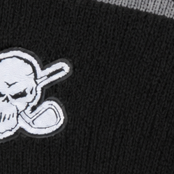 Close-up of the white skull patch on a black knit beanie.