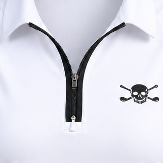 Close-up of a white polo's black zip fastening and skull-and-crossed-clubs chest logo.