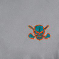 Close-up of a teal skull-and-crossed-clubs logo outlined in orange on grey polo fabric.