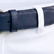 Close-up of a navy belt threaded through a white shorts belt loop.